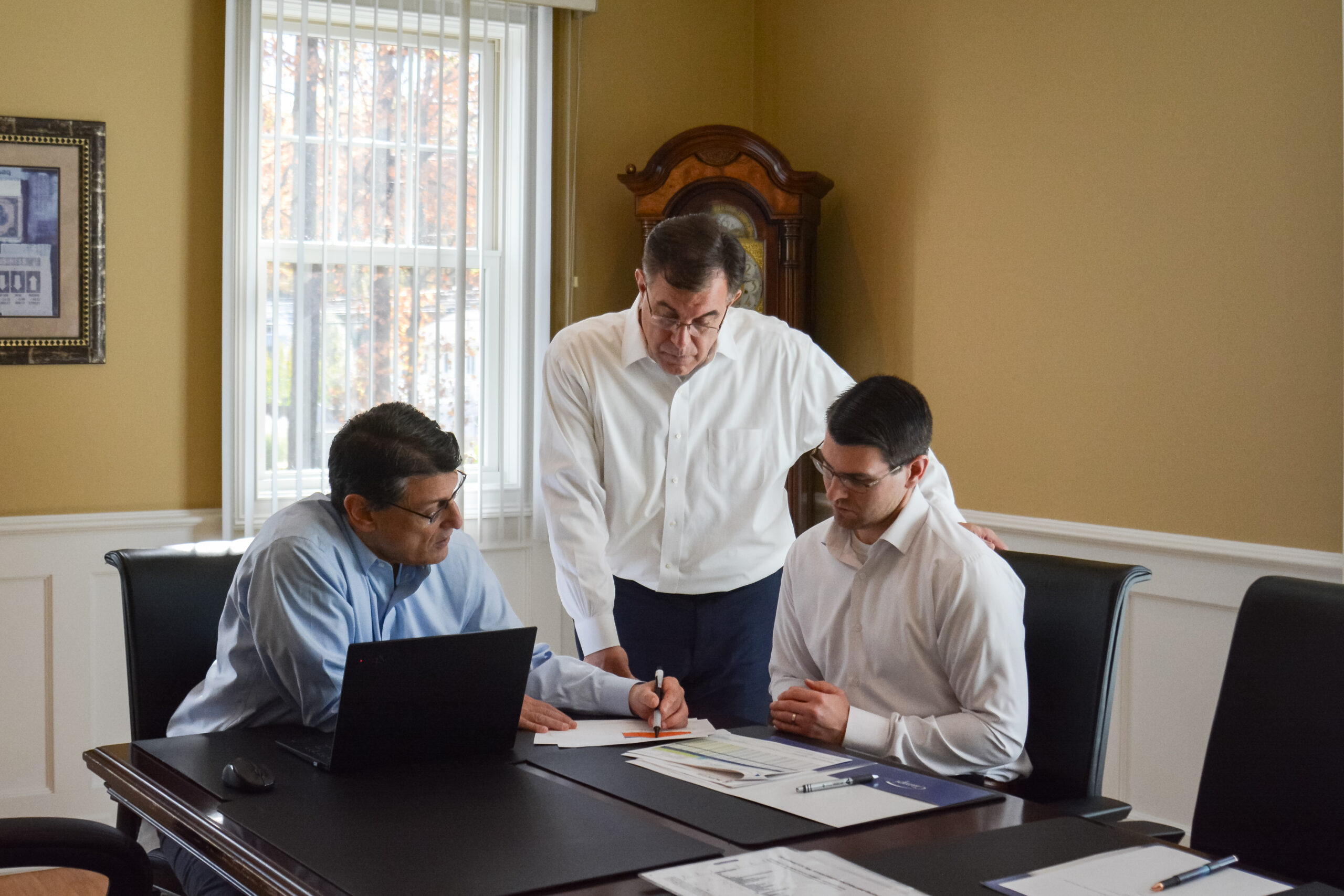 ciampi wealth management male team members photo inside at table