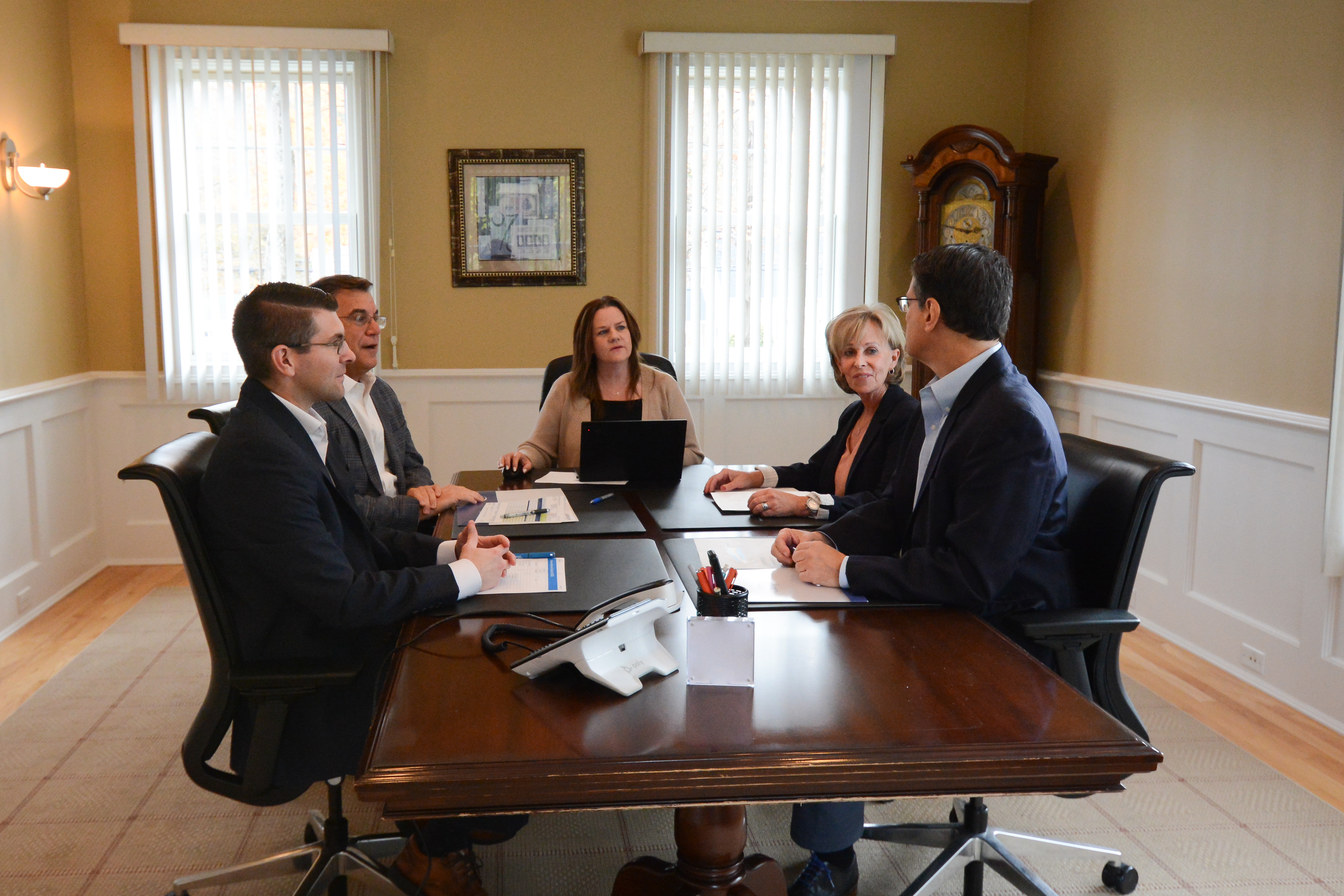 ciampi wealth management team photo inside at table